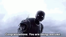 GIF de reacción de un robot con el subtítulo 'Congratulations. You are being rescued'.